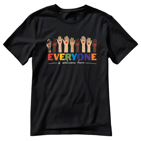 A black t-shirt with a colorful "Everyone is welcome here" design. Above the phrase, multicultural hands are shown with hearts on them.