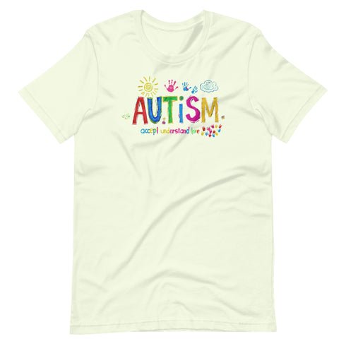 A light green t-shirt with a colorful autism awareness design. "Autism" is surrounded by colorful, childlike drawings with "accept understand love" underneath.