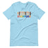A light blue t-shirt with a colorful "Everyone is welcome here" design. Above the phrase, multicultural hands are shown with hearts on them.