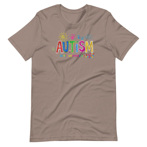 A brown t-shirt with a colorful autism awareness design. "Autism" is surrounded by colorful, childlike drawings with "accept understand love" underneath.