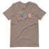 A brown t-shirt with a colorful autism awareness design. "Autism" is surrounded by colorful, childlike drawings with "accept understand love" underneath.