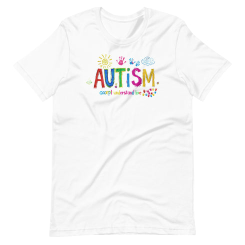 A white t-shirt with a colorful autism awareness design. "Autism" is surrounded by colorful, childlike drawings with "accept understand love" underneath.